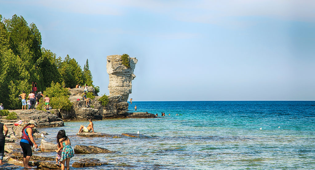 TOBERMORY, ONTARIO, CANADA, 13 August 2017: People sunbathing and swimming at Flower Pot Island, Tobermory, Ontario, Canada.